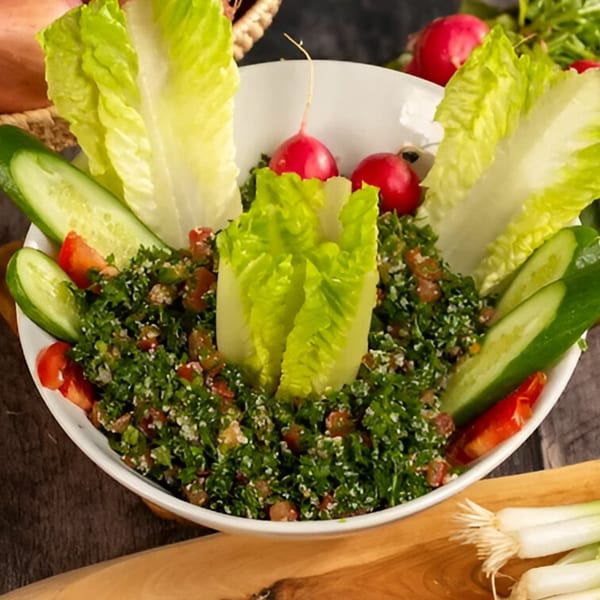 Tarbosh Mediterranean Restaurant's tabbouleh salad with fresh lettuce, cucumbers, tomatoes, and radishes.