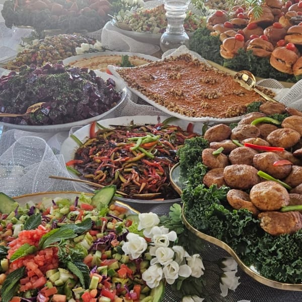 A lavish Mediterranean buffet spread with various dishes, including salads, dips, and appetizers.